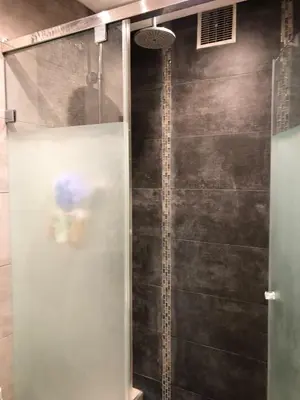 a shower with a glass door in a bathroom at Bright and Comfortable Stay by Stade Mohammed V in Casablanca