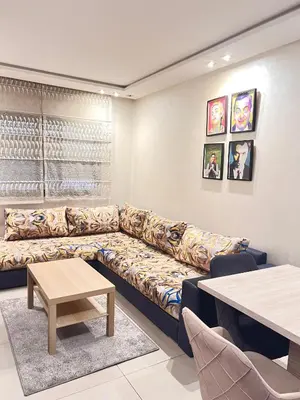 a living room with a couch and a table at Bright and Comfortable Stay by Stade Mohammed V in Casablanca