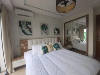 a bedroom with a white bed and a mirror at Havre de paix au cœur de Casa in Casablanca