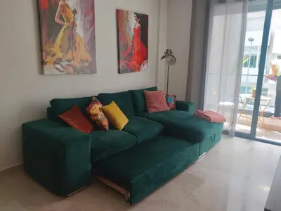 a green couch with colorful pillows in a living room at Havre de paix au cœur de Casa in Casablanca