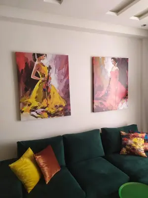 a living room with a couch and two paintings on the wall at Havre de paix au cœur de Casa in Casablanca