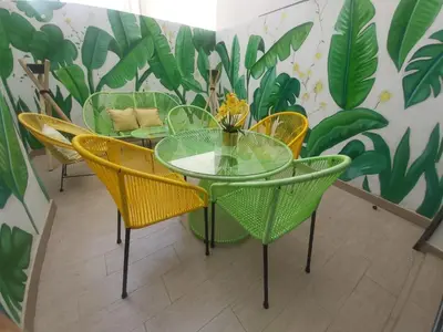a dining room with a glass table and yellow chairs at Havre de paix au cœur de Casa in Casablanca