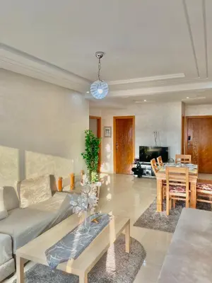 a living room with a couch and a table at Cozy Apartment in Rabat