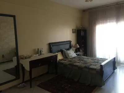 a bedroom with a bed and a desk and a mirror at Property located in a quiet area close to the train station and town in Casablanca
