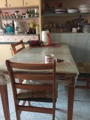 a wooden table with two chairs and a table with at Property located in a quiet area close to the train station and town in Casablanca