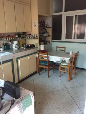 a kitchen with a table and chairs in it at Property located in a quiet area close to the train station and town in Casablanca