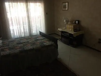 a bedroom with a bed and a desk and window at Property located in a quiet area close to the train station and town in Casablanca