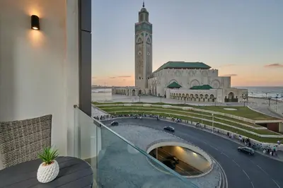 a view of a building with a clock tower at TheCasaEdition - Bel Azur - Sea View & Hassan II Mosqué Residency in Casablanca