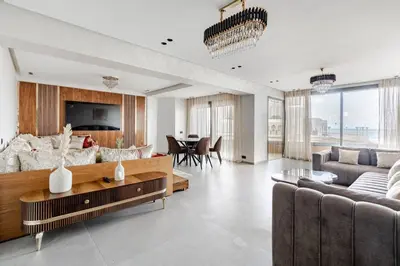 a living room with a couch and a table at TheCasaEdition - Bel Azur - Sea View & Hassan II Mosqué Residency in Casablanca