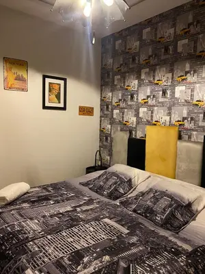 a bedroom with a bed with a wall covered in photos at Chez Bebel in Casablanca