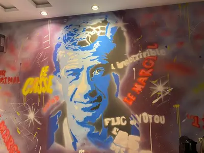 a wall with a painting ofgangsta rap artist at Chez Bebel in Casablanca