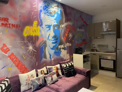 a living room with a purple couch in front of a mural at Chez Bebel in Casablanca