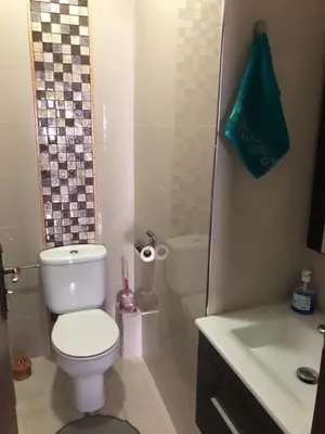 a bathroom with a toilet and a sink and a shower at Bel Appartement spacieux 3 pièces avec double salon Paisible & Proche de la Gare d'Agdal in Rabat