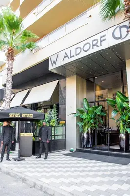 two men in suits standing outside of a building at W-Aldorf in Casablanca