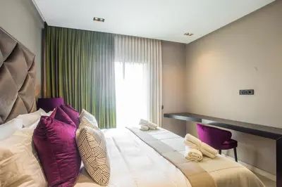 a bedroom with a large bed with purple pillows at W-Aldorf in Casablanca