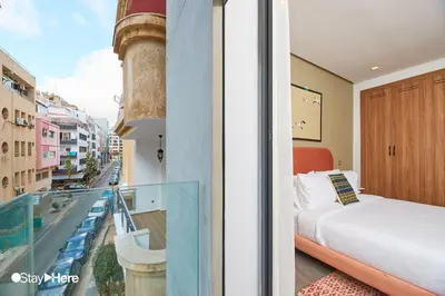 a bedroom with a bed and a balcony with a view at Stayhere Casablanca - Gauthier 2 - Contemporary Residence in Casablanca