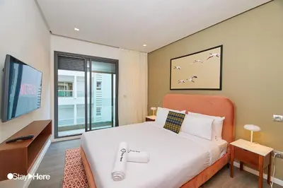 a bedroom with a large bed and a television at Stayhere Casablanca - Gauthier 2 - Contemporary Residence in Casablanca