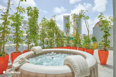 a hot tub on a balcony with potted plants at Stayhere Casablanca - Gauthier 2 - Contemporary Residence in Casablanca