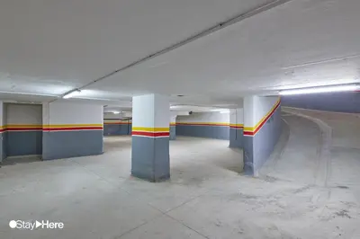an empty parking garage with columns and stripes on the walls at Stayhere Casablanca - Gauthier 2 - Contemporary Residence in Casablanca