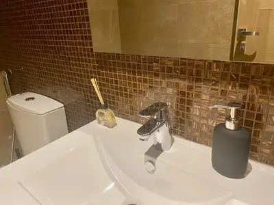 a bathroom with a white sink and a toilet at Luxueux Appartement avec Vue Panoramique, Proche de la Gare WELCOME STAY in Casablanca