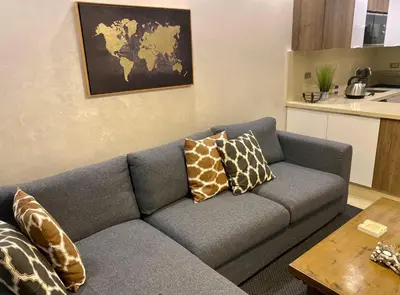 a living room with a gray couch with pillows at Luxueux Appartement avec Vue Panoramique, Proche de la Gare WELCOME STAY in Casablanca