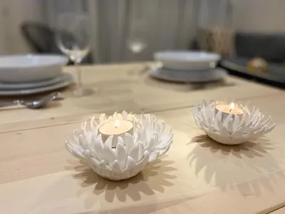 two candles are sitting on a wooden table at Luxueux Appartement avec Vue Panoramique, Proche de la Gare WELCOME STAY in Casablanca