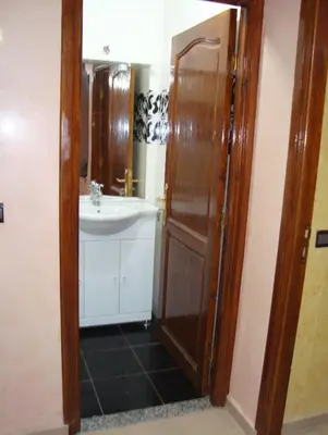 a bathroom with a sink and a toilet and a shower at Yasmine Appartements in Temara