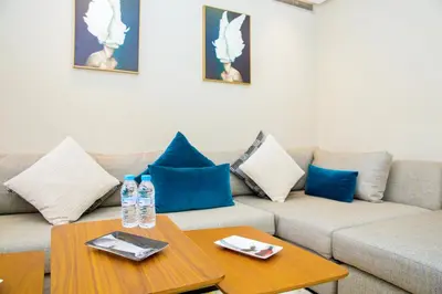 a living room with a couch and two tables with water bottles at Top flat at central Massira Maarif in Casablanca