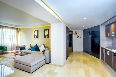 a living room with a couch and a table at Top flat at central Massira Maarif in Casablanca