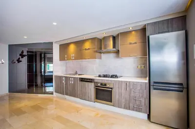a large kitchen with stainless steel appliances and cabinets at Top flat at central Massira Maarif in Casablanca