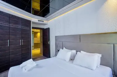 a bedroom with a bed with white sheets and pillows at Top flat at central Massira Maarif in Casablanca