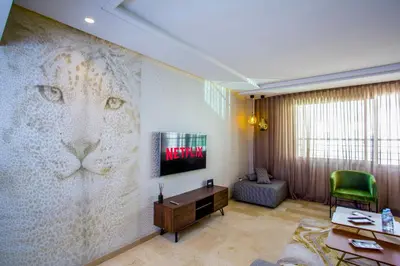 a living room with a mural of a lion on the wall at Top flat at central Massira Maarif in Casablanca