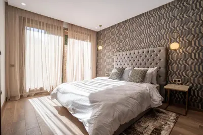 a bedroom with a large bed and a large window at Fresh maarif flat in new building in Casablanca