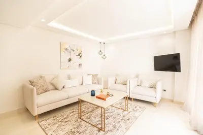 a living room with a couch and a table at Fresh maarif flat in new building in Casablanca
