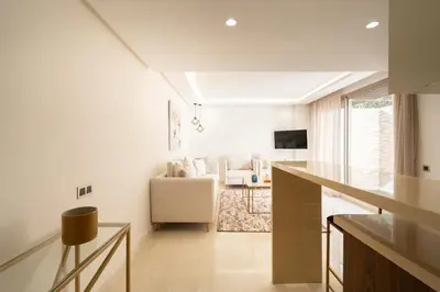 a white living room with a couch and a table at Fresh maarif flat in new building in Casablanca