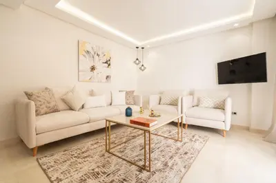 a living room with a couch and a table at Fresh maarif flat in new building in Casablanca