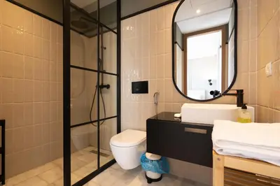 a bathroom with a sink and a toilet and a mirror at c4 .super appartement with parking in Casablanca