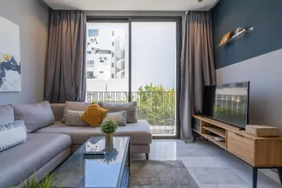 a living room with a couch and a tv at c4 .super appartement with parking in Casablanca
