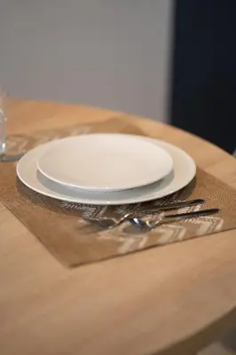 a white plate sitting on top of a wooden table at c4 .super appartement with parking in Casablanca