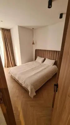 a bedroom with a large bed with white sheets at Superbe studio avec une belle terrasse à Gauthier in Casablanca