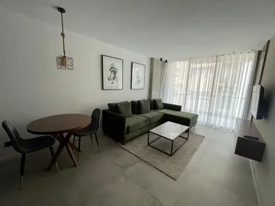 a living room with a green couch and a table at Superbe studio avec une belle terrasse à Gauthier in Casablanca