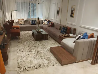 a living room with a couch and a table at Appartement la perle de Nouaceur in Nouaceur