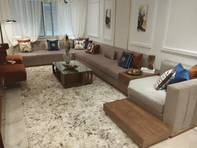 a living room with a couch and a table at Appartement la perle de Nouaceur in Nouaceur