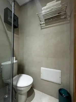 a bathroom with a toilet and a towel rack at Ocean Palm Aρραrt Pοοl Vieω in Casablanca
