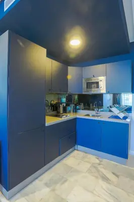 a kitchen with blue cabinets and a blue ceiling at Amazing view Fast WiF with Gym near tramway in Casablanca