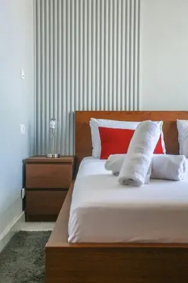 a bedroom with a bed with red and white pillows at Amazing view Fast WiF with Gym near tramway in Casablanca