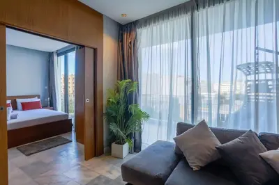 a living room with a couch and a large window at Amazing view Fast WiF with Gym near tramway in Casablanca