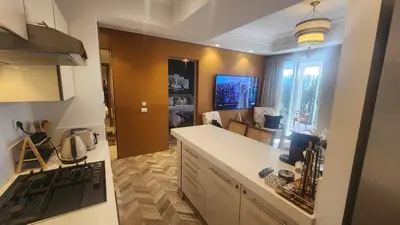 a kitchen with a stove and a counter top at Magnifique appartement Casa Finance City in Casablanca