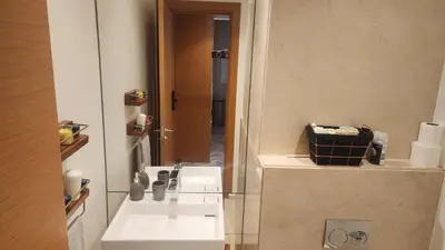 a bathroom with a white sink and a mirror at Magnifique appartement Casa Finance City in Casablanca