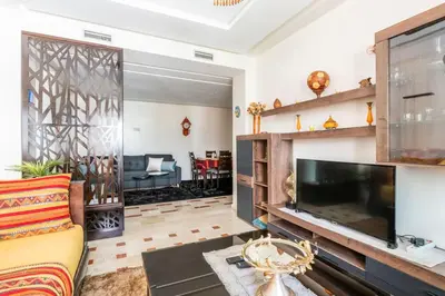 a living room with a large flat screen tv at Layover Guest House Apartment & parking Rabat Agdal City Center in Rabat